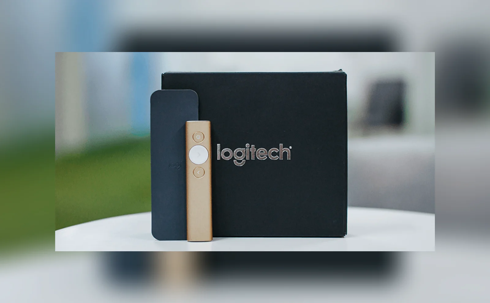 Logitech Spotlight presenter remote next to its box